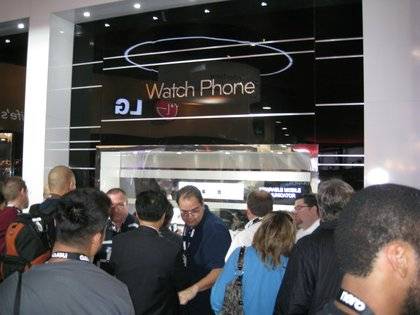 A mad throng -- mad, I tell you! -- cranes for a look at the Touch Watch Phone.