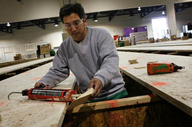 New bowling digs: At Cashman Center, Rodolfo Gonzalez works on the framework of what will be one of the largest bowling centers in Southern Nevada for the upcoming U.S. Bowling Congress Open Championships, which will run through August.