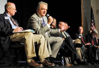 Assemblyman Joe Hardy, left, looks on as Clark County Commissioner Steve Sisolak responds to a suggestion by a member of the audience regarding generating new sources of income for the school district during tough economic times at a town hall meeting Thursday inside the Boulder City High School auditorium.