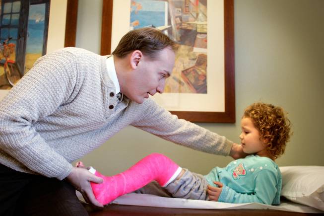 Dr. David Stewart puts a cast on patient Makenna Millett, 3, during his office hours in Las Vegas on Friday, Jan. 2, 2009. Dr. Stewart is one of just five pediatric orthopedic surgeons in southern Nevada. Because of cuts in the reimbursement rates, he and his partners are no longer accepting Medicaid patients  