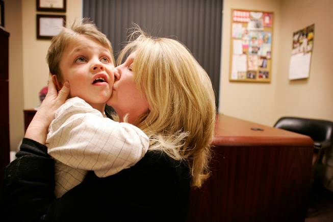Pierce Laurent, 5, gets a hug and kiss from his mother Robin after speech therapy at Henderson Speech Hearing and Language Center on Wednesday, Dec. 24, 2008. Pierce has been diagnosed with autism and the neurological disorder apraxia, and will need intensive daily therapy if he's ever to become independent, says his mother.