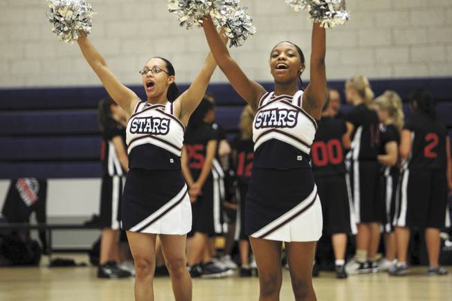 Ashley Justice, left, cheers during a basketball game at Andre Agassi Preparatory Academy in December. Justice will be among the Class of 2009, the charter school's first-ever commencement this spring.