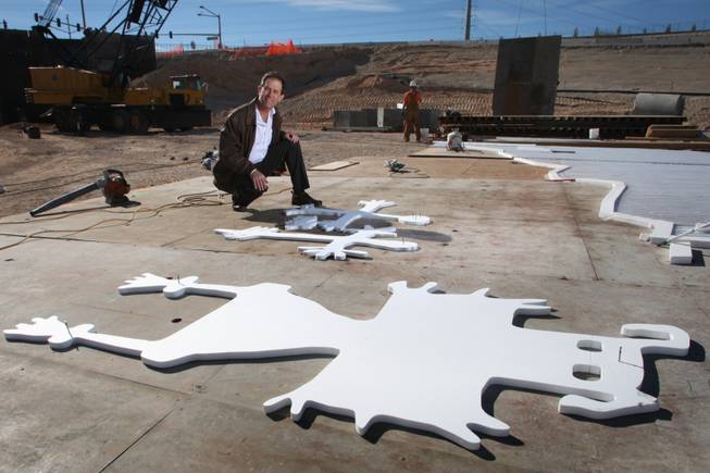 Jeffrey Rhoads, considered the godfather of public art on bridges and other infrastructure in Southern Nevada, kneels beside cutouts used to create Native American-style petroglyphs in concrete. Rhoads' work inspired the state Transportation Department to welcome such decorations on road projects. 