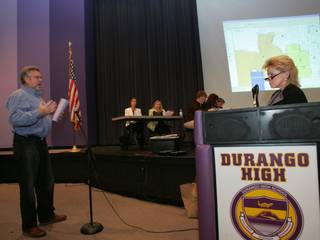 Sharon Dattoli, right, director of demographics and zoning for the Clark County School District, listens as Richard Taylor, whose child attends Sig Rogich Middle School, speaks during a public input meeting Tuesday about school attendance boundaries at Durango High School.