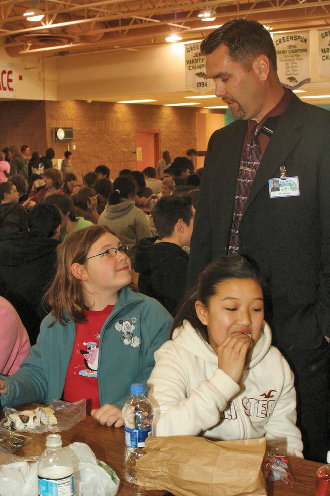 Warren McKay, the newly promoted principal of Greenspun Middle School, stops to speak with Dior DeSormeau, left, and Kayla Auyong, both seventh graders, during his rounds during lunch.