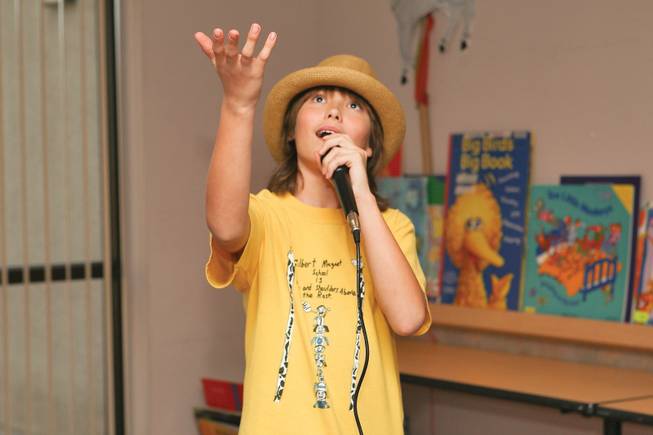 Angelo Moliner, 10, performs "Somewhere Over the Rainbow" with a Hawaiian flare similar to Israel Kamakawiwo'ole during the teen karaoke event Saturday at the Enterprise Library.