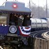 President-elect Barack Obama, far right, waves from the back of a train to the waiting crowd at the Claymont Amtrak rail station as it moves through Claymont, Del., on Saturday.
