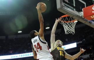 Rene Rougeau dunks over Adam Waddell of Wyoming Saturday at the Thomas & Mack Center. The Rebels beat Wyoming 83-66.
