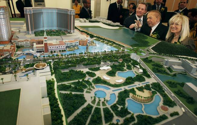 In better times: William Weidner, left, and Sheldon Adelson, top executives of Las Vegas Sands, look at a model during the groundbreaking ceremony in March 2007 for the Shangri-La Hotel, Traders Hotel, Sheraton Hotel and St. Regis Hotel, all part of the company's ambitions plan to develop Macau's Cotai Strip.
