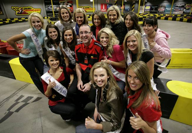 Miss America contestants gather around Brad Mark, the managing partner ...