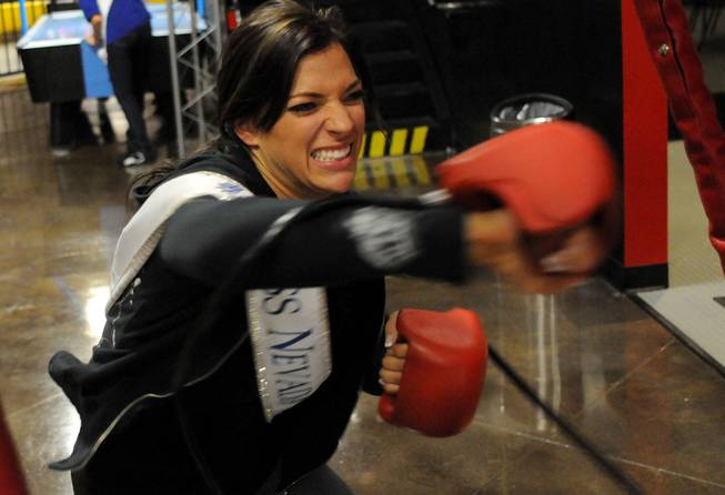 2009 Miss Nevada Julianna Erdesz plays a boxing arcade game ...