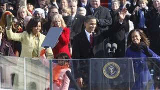 President Barack Obama, first lady Michelle Obama and their daughters, Malia, right, and Sasha, wave after Obama was sworn in at the U.S. Capitol in Washington. 