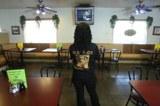 Waitress Iesha Hall watches television coverage of President Barack Obama's inauguration at the M&M Chicken and Waffles restaurant on Martin Luther King Jr. Boulevard. 