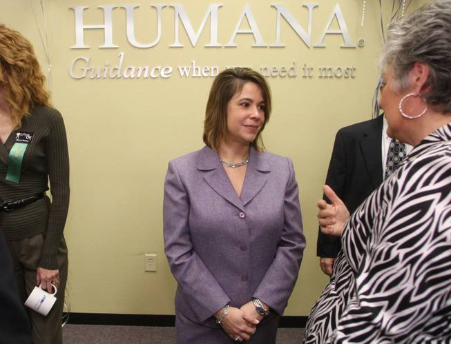 Providing guidance: Oraida Roman, center, president of Humana Nevada, listens to a guest during the opening of Humana's newest guidance center in Henderson on Jan. 13. Humana is hoping to lower its costs by involving its insured in healthly lifestyles.