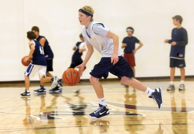 Tanner Howell dribbles the ball across the court during Elton M. Garrett Middle School's basketball practice.
