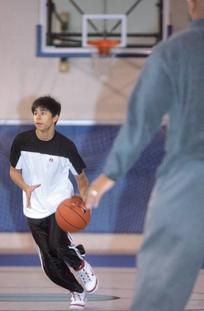 While running through a drill, C.J. Castro, 14, looks for a teammate to pass to during Green Valley Christian's basketball practice at the Boys and Girls Club of Las Vegas.
