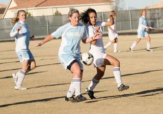 Liberty forward Minerva Mnassis (8), right, vies for the ball with a Foothill defender during a home game on Jan. 9.
