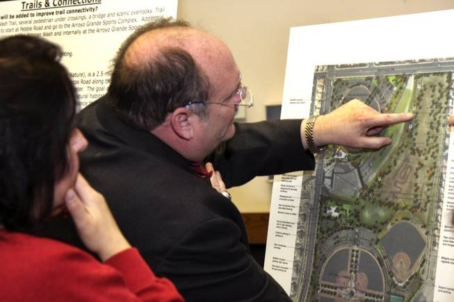 David Flatt, right, and Martine Jordan point to a map while talking with Park Project Manager Patricia Ayala, not pictured, during Thursday's neighborhood meeting about the Arroyo Grande Sports Complex at the Henderson Convention Center.
