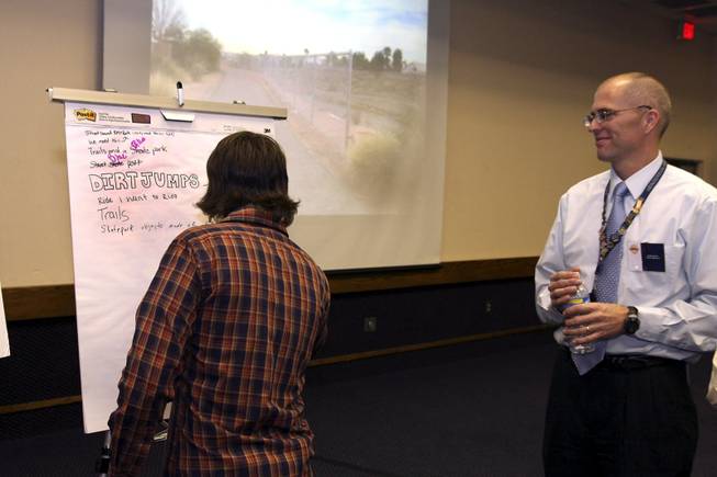 Public Works Project Engineer Scott Jarvis, right, looks on as a teenager resident, left, provides his input about what the Arroyo Grande Sports Complex needs during a public meeting at the Henderson Convention Center.
