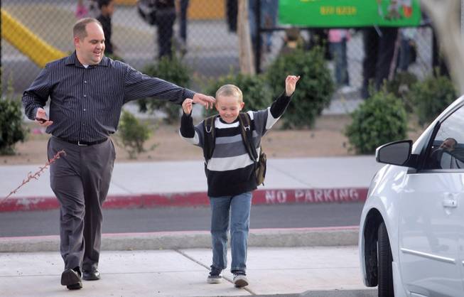 Brian Baker plays around with his son, William, 6, he picks William up from Linda Givens Elementary School. Givens is one of nine Summerlin schools that might go from a nine-month to a year-round schedule to alleviate crowding.
