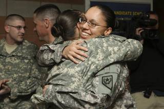Sgt. Jennifer Ewing, right, is greeted with a hug from Staff Sgt. Luciana Irenze after serving in Iraq for a year with the 140th Military Police Brigade Liaison Detachment during the welcome-home celebration Friday at the Nevada Army National Guard Readiness Center.