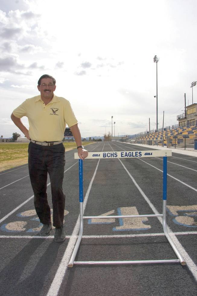 Former Boulder City High School track coach Bruce Momsen poses on the track he saw built under his more than 25-year career. Momsen will be inducted into the NIAA Hall of Fame on Feb. 26.