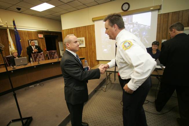 Boulder City Mayor Roger Tobler gets an appreciative handshake from Fire Chief Kevin Nicholson after Tobler delivered his State of the City speech on Tuesday. 
