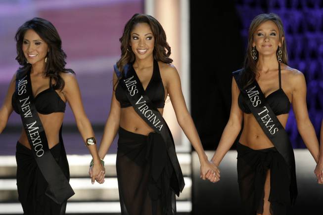 Miss Virginia Caressa Cameron, center, waits with Miss New Mexico Nicole Miner, left, and Miss Texas Kristen Blair after competing in the swimsuit competition at the 2010 Miss America Pageant at Planet Hollywood. Cameron was later crowned Miss America.