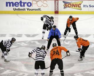 The Wranglers wear jerseys with horizontal black and white stripes while the Condors sport orange jumpsuit-style jerseys. The referees wear police outfits to fit with the theme of the night.
