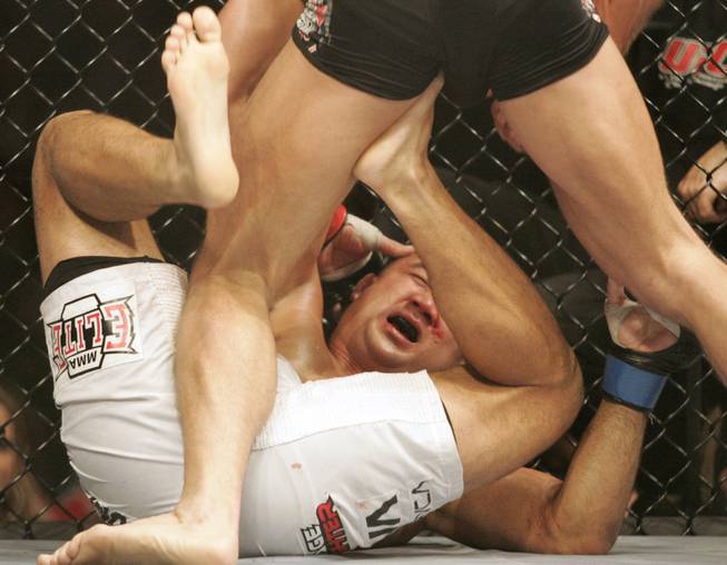 Georges St. Pierre pounds on B.J. Penn during the third ...