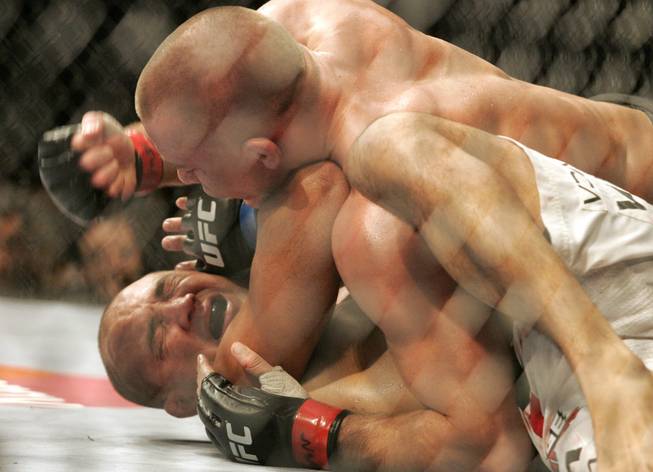 Georges St. Pierre pounds on B.J. Penn in the fourth ...