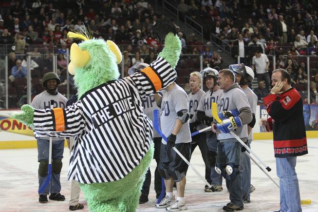 Henderson police officers celebrate with The Duke, the Wranglers' mascot, after winning the sixth annual Intermission Charity Broomball Contest 1-0 against the North Las Vegas Fire Department Feb. 2, 2009, at the Orleans Arena.