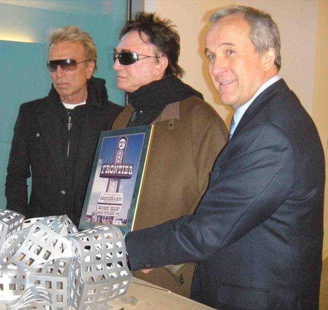 Larry Ruvo presents Siegfried and Roy with a photo of the first marquee the duo ever headlined. 