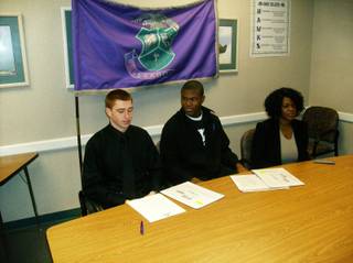 Silverado football players Michael Wadsworth, left, and Keenan Graham,
center, wait to sign their national letters of intent Wednesday, Feb. 4, 2009,  in a
conference room at Silverado. Graham's mother, Jacqueline Maharaj, is at
right. Graham inked with UCLA and Wadsworth picked Hawaii.