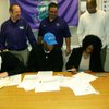 Silverado safety Michael Wadsworth, front left, and defensive end Keenan
Graham, front center, sign their national letters of intent on Wednesday, Feb. 4, 2009.
Graham inked with UCLA and Wadsworth picked Hawaii. Also pictured are
Graham's mother, Jacqueline Maharaj, at bottom right, Silverado Athletic
Administrator Jerry Cornell (back left), Silverado football coach Andy
Ostolaza (back center) and Silverado basketball coach Ron Childress (back
right).