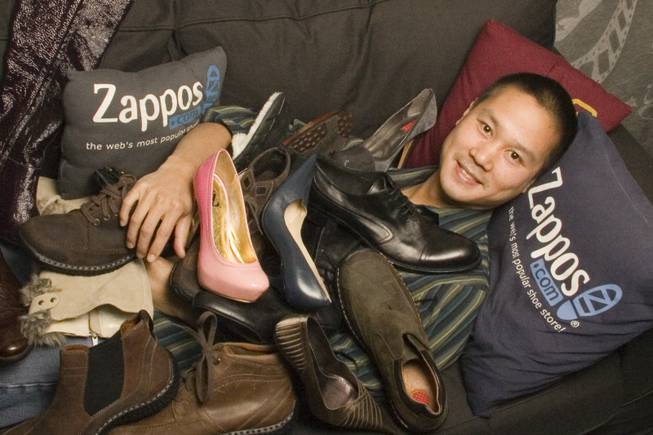 Zappos.com CEO Tony Hsieh poses with some of his company's merchandise.