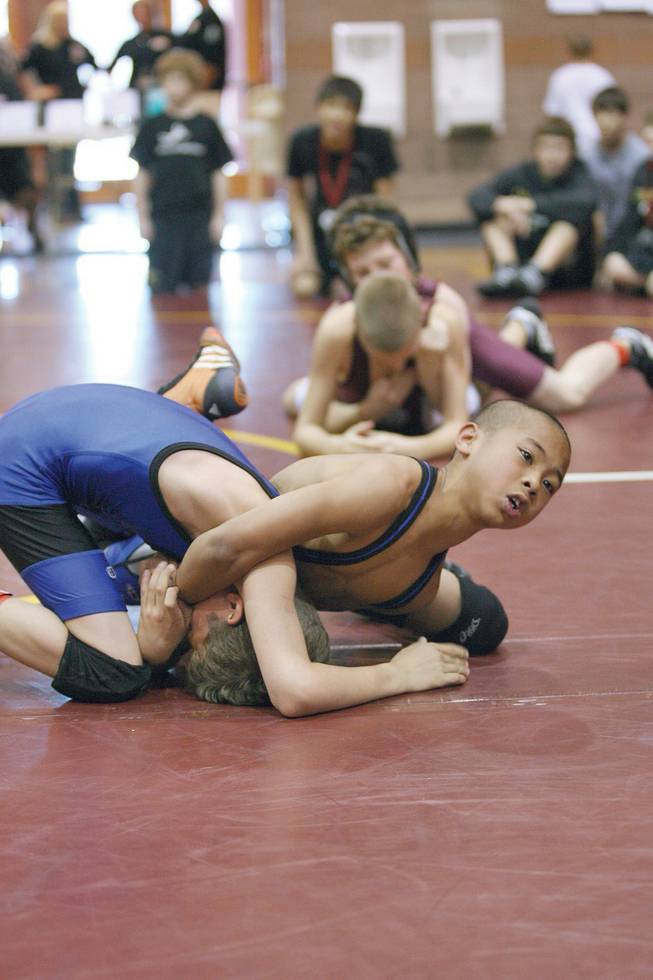 Green Valley's Kaden Lizares grapples Independent wrestler Lawrence Vigil during the Crusader Invitational Wrestling Tournament at Faith Lutheran High School on Jan. 31.