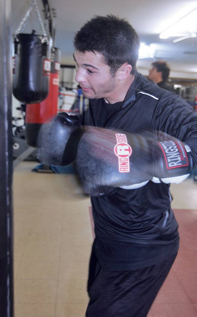 Bradley Blankenship, a UNLV student and boxer, pounds the punching bag while he trains at Elite Boxing Gym.  Formally a skilled football player for Sierra Vista, Blankenship gave up the sport to pursue boxing.
