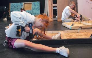 Callae Waller, left, and Sasha Vancura work on the two-story set of Faith Lutheran's upcoming play, 