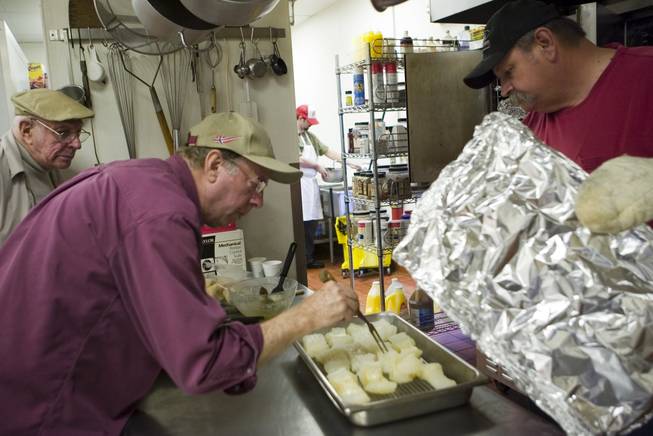 Bob Sturgeon, center, and John Hansen, right, make a last minute check of the lutefisk before serving it at the Boulder City Elks Lodge at Saturday's 11th annual event, organized by the Sons of Norway.