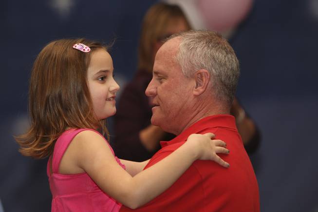 Gary Mayo holds his daughter, Carmela, 8, in his arms ...