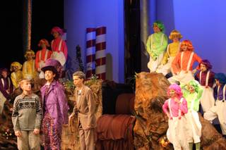 Barry Fortgang, a junior, plays Willy Wonka, second from the left, as he show Tanner Nelson, a sophomore playing Charlie Bucket, his chocolate factory during Friday's performance of 