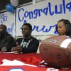 Kerwynn Williams, in between parents Kendall and Ingrid Williams, addresses family and friends at his signing party in the library at Valley High School on Wednesday.