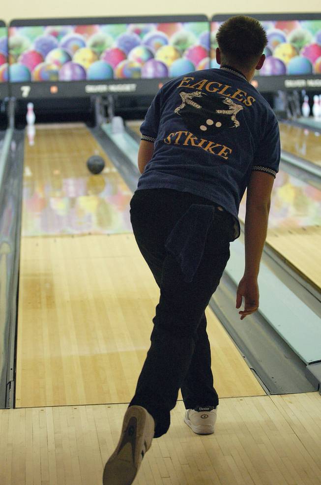 Boulder City junior Dylan Martens, 17, pick up a spare during a bowling meet against Desert Pines on Feb. 5.