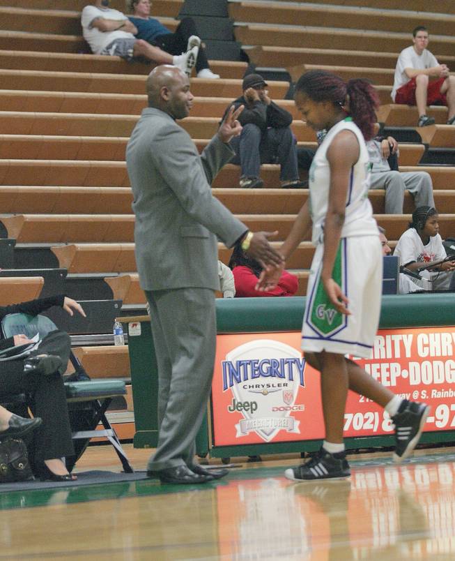 Green Valley girls basketball coach Lorenzo Jarvis, left, talks to senior Vajae Robinson as she walks off the court during a home game against Southeast Career and Technical Academy.