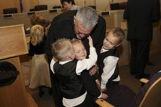 Judge David Gibson receives congratulatory hugs from his three grandsons, from left: Thomas Anderson, Jared Lamoreaux, Jr., and Nathan Anderson. Gibson was sworn in as Justice of the Peace during the Investiture Ceremony Thursday at Henderson City Hall.
 