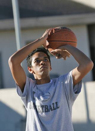 Liberty Baptist Academy junior Mikel Simmons Jr. lines up a shot during practice.