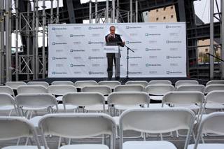 Larry Ruvo does a sound check just before a press conference announcing the Lou Ruvo Brain Institute's partnership with the Cleveland Clinic, at the brain institute in Las Vegas on Tuesday.
