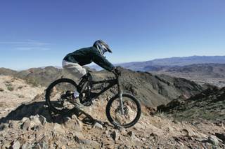 A rider takes part takes part in the Super D race during the Mob 'N Mojave downhill cycling competition at Bootleg Canyon in Boulder City on Saturday.