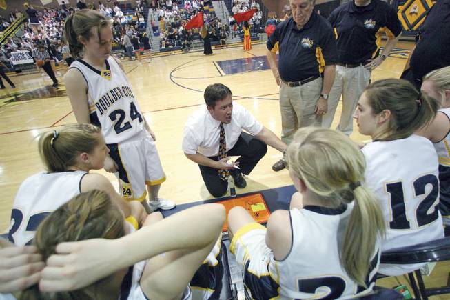 Boulder City girls' basketball coach Brian Lemmel, center, talks to his team during a home game against Virgin Valley on Feb. 13.
